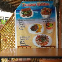 Poster of veg options including veg burgers and veg ceviches at Carmita's Pancake House Restaurant in Montanita