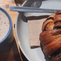 Oat milk latte & cinnamon roll at Orchard Lane Coffee House in Folkestone