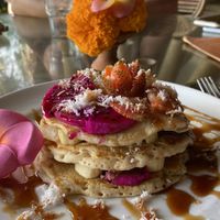 Vegan pancakes stacked with coconut and fruit  at Yellow Flower Cafe in Ubud