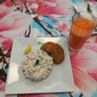 Almond patties with salad and orange carrot juice at bistRAWveg - Cerny Most Shopping Centre in Prague