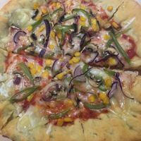 Vegan pizza with cheese-stuffed crust. Get the garlic mayo for crust-dipping purposes... at Happy Friday Kitchen  in Oxford