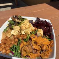 Made my own bowl!! Really good! Kale,quinoa, roasted chickpeas, roasted sweet potatoes, roasted Brussels , tofu, roasted beets with a vinaigrette dressing at Enlightened Cafe in Ventnor