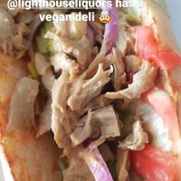Chipotle Chick'n with red onion, pickles in a sub roll. at Bo Brooks' Lighthouse Liquors in Baltimore
