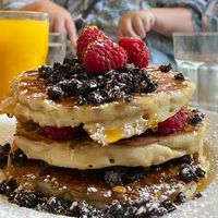 Vegan pancake stack with syrup, Oreos and raspberries (more of everything in between the layers)  at POG - Bachelor's Walk in Dublin