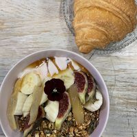 Granola and croissant  at Aujourd'hui Demain Cafe in Paris