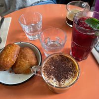 Cappuccino, pain au chocolates and drink with hibiscus  at Aujourd'hui Demain Cafe in Paris