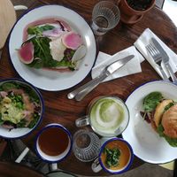 Avocado toast, mizuna salad, burger, soup, matcha latte at Aujourd'hui Demain Cafe in Paris