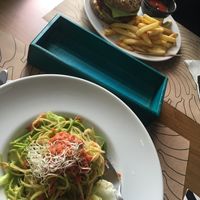 our lunch! Veggie burger and raw red sauce pasta. at Bananas Veggie & Raw Cuisine in Novi Sad