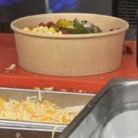 A “vegan” burrito bowl that was not supposed to have cheese, but did.  at Burrito Loco - Spalena in Prague