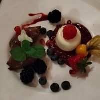 Dessert: Variation von Panna Cotta auf einem Himbeerspiegel, Mousee au chocolat und frischem Obst at Alex Kitchen in Heide