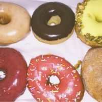 top left glaze, chocolate, pistachio, bottom left blueberry raspberry with sprinkles, & cinnamon.  at Revolution Doughnuts in Atlanta