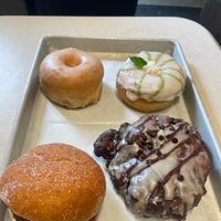 ~$22 for (left to right) vanilla bean, mint julep, peach, banana choc fritter.  at Revolution Doughnuts in Atlanta