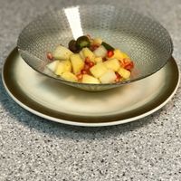 Fruit salad for desert: pomegranate, (pine)apple, kiwiberries, melon and grated ginger at Groenten Zonder Grenzen - GZG in Rotterdam