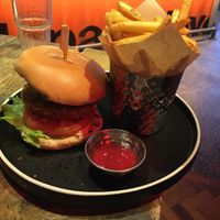 Chicken style burger with spicy ketchup and fries at Turtle Bay in Guildford