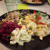 Falafel loaf on garlic potatoes, with waldorf salad, beetroot salad, ginger-sesame beans and veggies (13,50e) at Anne's Vege in Espoo