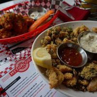 Oyster Mushroom Calamari with Dill Sauce and Buffalo Boneless Wings at Mythology in Toronto
