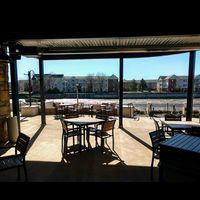 Outside seating for all the shops. Two floors of outdoor seating. The bottom floor has an overhead heater and outdoor electric fire pit. Over looking Rock River and close to many local shops downtown. WiFi works outside by as well.  at The Bodacious Family of Shops in Janesville