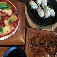 Tomizza (Base Pizza), dumplings (Eight Grains) and deep fried cauliflower (Bacon Bros) - all vegan.  at Little High Eatery in Christchurch