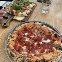 Canotti marinara with added feta in front, a pinsela pizza in the back.   at Vegazzi Specialty Pizzeria in Budapest