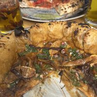 The bbq pizza with orange & margarita in back  at Vegazzi Specialty Pizzeria in Budapest