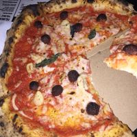 pizza of the day with cheese and meatballs , a lot less basil than advertised at Vegazzi Specialty Pizzeria in Budapest