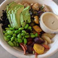 Vegan bowl with black forbidden rice, baked tofu, roasted root veggies, edamame, avocado, and tahini citrus miso dressing at Honest Mary's in Austin