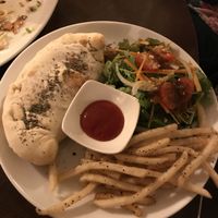 Vegan calzone with fries and salad at Slices in Osaka