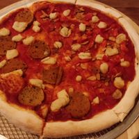 Half vegan pepperoni pizza and garlic and tomato at Slices in Osaka