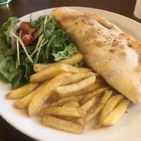 Vegan calzone , comes with fries and salad  at Slices in Osaka