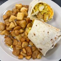 Loaded Vegan Breakfast Burrito with a Side of Spuds- 12in Wrap Stuffed with Spuds, Grilled Onions, Bell Peppers, Tofu Eggs, Vegan Mayo, and Daiya Mozzarella at Ocala's Downtown Diner in Ocala