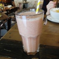 Smoothie with orange, strawberry, banana, cinnamon, honey and ginger at Deli Linz in Linz