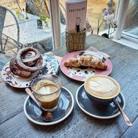 The incredible cinnamon roll with delicious coffees.  at East Village Cafe in Bristol