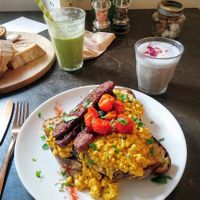 Scrambled tofu with tempeh, shakshuka, green smoothie and blue skies latte at East Village Cafe in Bristol