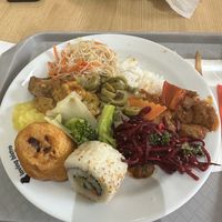 Fried cauliflower, 2 sushi pieces, rice noodles, white rice, curried tofu and seitan, veggies, mashed potatoes, beet salad, and green olives  at Loving Hut - Spalena in Prague