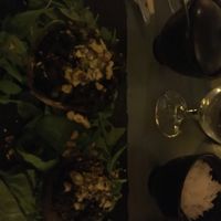 Stuffed portobello mushrooms with black olive tapenade, truffle, salted nuts on a bed of spinach & rocket at Bubbles and Bites in Cascais