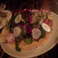 CAST IRON SOCCA. (MARKET GREENS. GREEN HERB PUREE. AVOCADO. ) at XYST in New York City