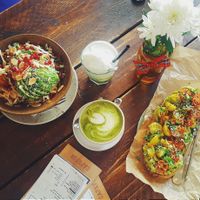 avocado toast, matcha latte with soy milk, salad with avocado and almond slices at Cafefin in Prague