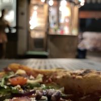 Kalapizza pizza corner on the street with tables outside 😋  at Kalapizza in Wroclaw