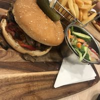 Vegan burger w/ chips and salad. Amazing taste.  at Whispers Cafe in Parramatta