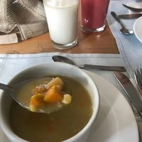 Oat milk and strawberry passion fruit juice. Soup of the day: pumpkin, corn and plantain. at El Arbol de la Vida - Maybe closed in Medellin