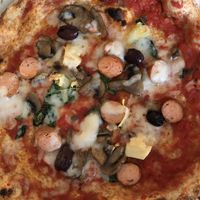 “Picciotta” pizza with rice mozzarella, vegan sausage, tomato, artichokes and olives - wholemeal and chickpea flour dough  at Rossopomodoro in Trieste