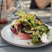 The summer salad is delightful. Avocado dressing and cashew cream savoury in the sweet watermelon base. So yum! at W6 Garden Centre Cafe in West London