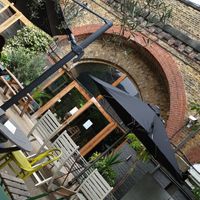 Outdoor space under the arches at W6 Garden Centre Cafe in West London