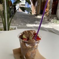 Coconut yogurt with agave syrup, almond butter, goji berries, pumpkin seeds, chocolate chips and fresh fruit   at Fresh Yogurt & More in Kos