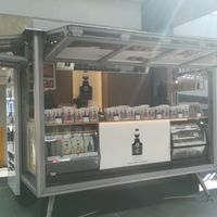 Many shelves full of delicious nuts and snacks, with a dessert cabinet on the lower right.  at Apron Empowered - Westfield Albany in Auckland