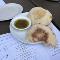 Pita and olive oil given At the beginning is vegan and cooked on site in a stone oven  at Shaya Restaurant in New Orleans