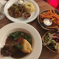 Haggis, chickpea and eggplant curry, sweet poto fries and garlic aioli, house salad  at Henderson's Shop and Salad Table in Edinburgh
