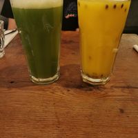 Cucumber and ginger juice (green) and Orange and passion fruit juice (yellow) at Vantra Vegan in London