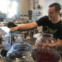 Filling my reusable container ... loving their fresh daily juices wow purple lemonade l at Organic Junkie in Corona