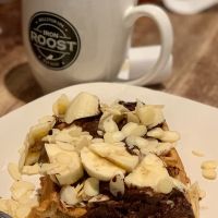 Build your own Vegan waffle with avocado cocoa mousse, bananas and almonds (request no butter, no powdered sugar). I couldn’t wait to try so picture shows it 1/3 eaten. at Iron Roost in Ballston Spa